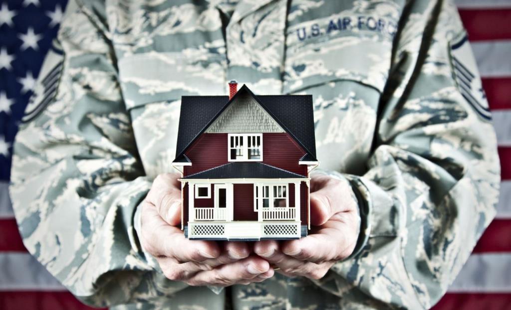 Image of veteran holding a toy home